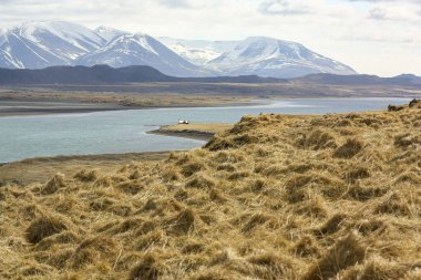 Kara ve dağlar karla kaplı, okyanus kenarında..