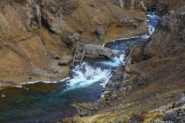 Egy kis vízesés egy keskeny folyó szurdokban Izlandon. — Stock Fotó