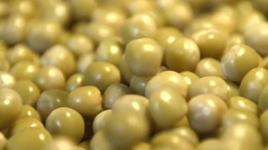 Konserve yeşil bezelye. 2 tekila. Ağır çekim. Yatay ve dikey pan. Yakın-up.1. konserve yeşil bezelye düşüyor. Yatay (sağdan sola) panorama.2. Dikey (aşağıdan yukarıya) panorama.