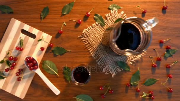 Cherry juice and cherry on the table. — Stock Video