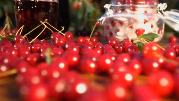 Cherry juice on the background of growing cherries. — Stock Video