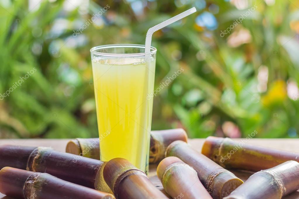 Sugarcane fresh juice for a detox diet Organic fruits on woode Stock