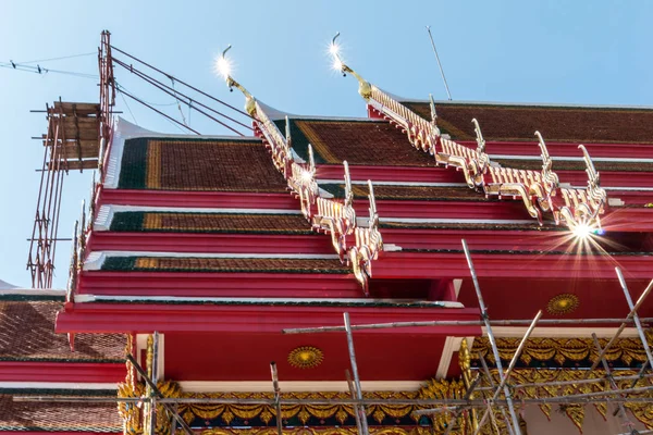 Temple roof vintage Thai style with against blue sky background