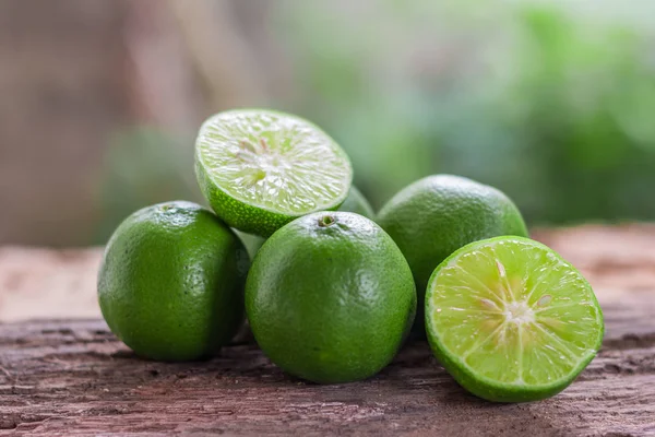 Lemons - Green lemons from the garden on wooden background, Select focus, Soft focus and blur