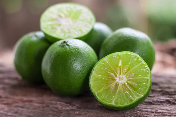 Lemons - Green lemons from the garden on wooden background, Select focus, Soft focus and blur