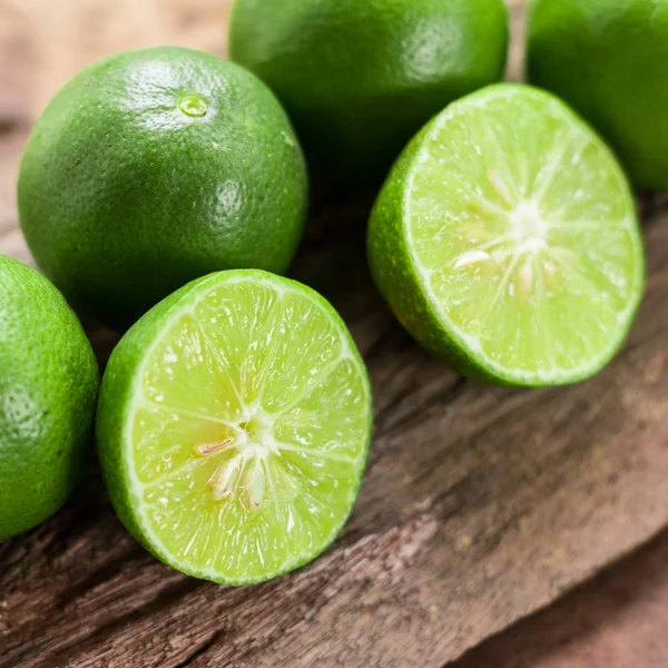 Lemons - Green lemons from the garden on wooden background, Select focus, Soft focus and blur