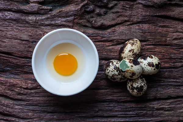 Vaktelägg - vaktel ägg i en keramikskål på gamla bruna trä yta — Stockfoto