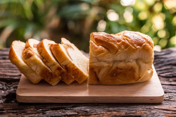 Pão fatiado fatias caseiras de pão em uma placa de madeira e xícara — Fotografia de Stock