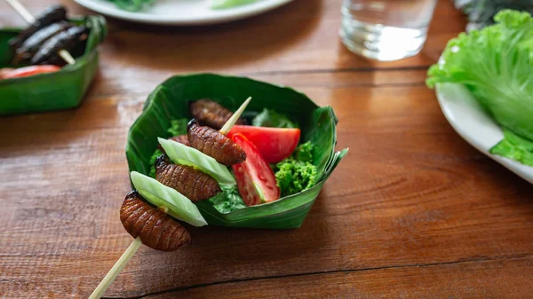 Fried Worm, Insect food with vegetables in the bowls made from b