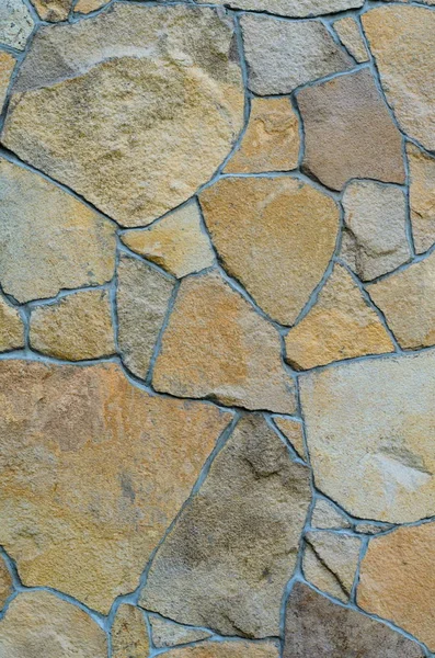 Background of a stone wall cladding texture, brown stone bricks — Stock Photo, Image