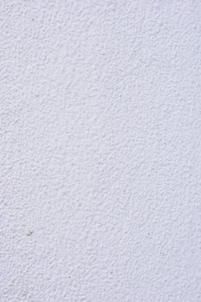 Background of a white stucco coated and painted exterior, rough cast of cement and concrete wall texture, decorative coating