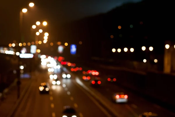 City traffic lights at night blurred bokeh defocused urban background — Stock Photo, Image