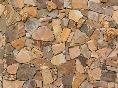 Decorative modern stone wall of chipped stone for background clipart