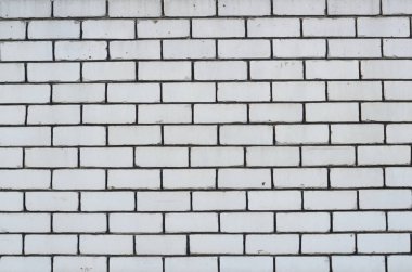 Arka plan doku bir beyaz tuğla duvar çimento ile dikişleri 