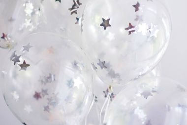 Tavan altında Gümüş Yıldız ile uçan beyaz balonlar
