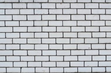 Arka plan doku bir beyaz tuğla duvar çimento ile dikişleri 