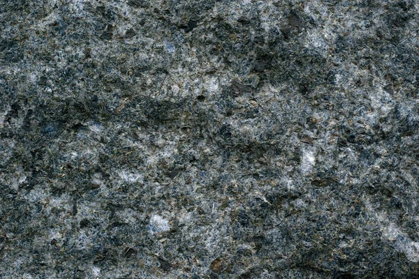 Textura de pedra escura natural com inclusões, fundo — Fotografia de Stock