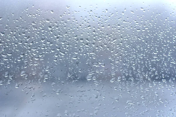 Gouttes de pluie sur verre de fenêtre bleu propre — Photo