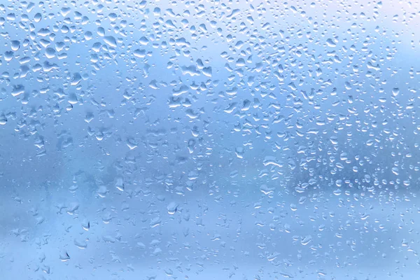 Rain drops on clean blue window glass — Stock Photo, Image