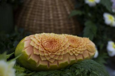 Thai fruit carving and food garnish on papaya clipart