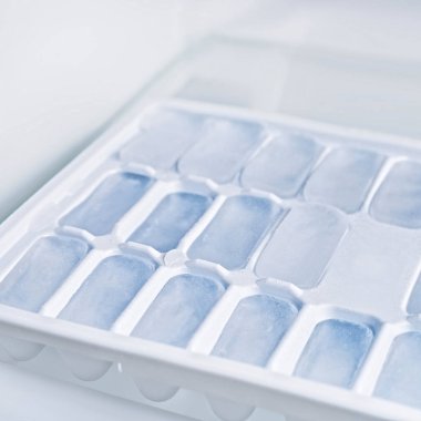 The ice in the refrigerator. Molds for freezing clipart