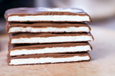 milk chocolate with coconut filling, cutting chocolate into small pieces, handmade chocolate bars