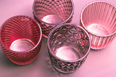 Colored glass products close-up, modern translucent cups clipart