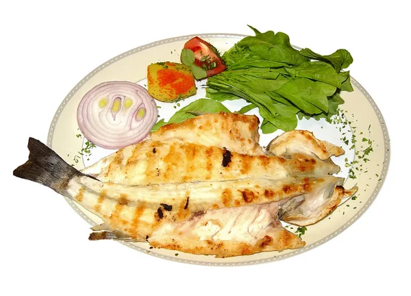 Otlar ve soğan ile bir tabak kızarmış balık