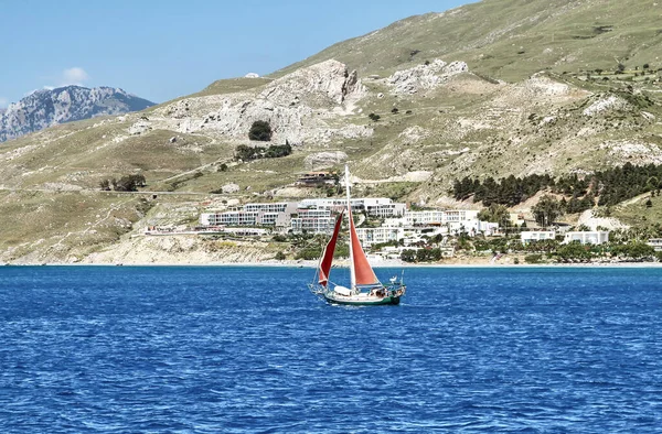 Kos Adası açıklarında kırmızı yelkenli bir yat. Yunanistan