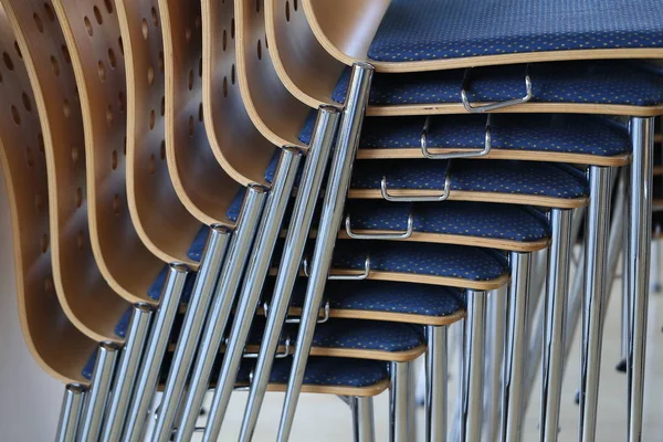 Stacked chairs / A stack of blue chairs