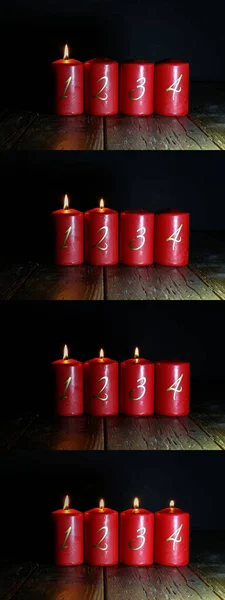 Velas de advento vermelho estão em um chão de madeira — Fotografia de Stock