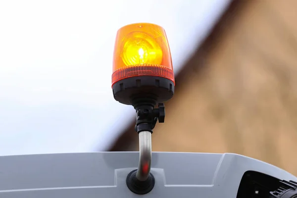 Orange flashing light on the transport on a blurred background.