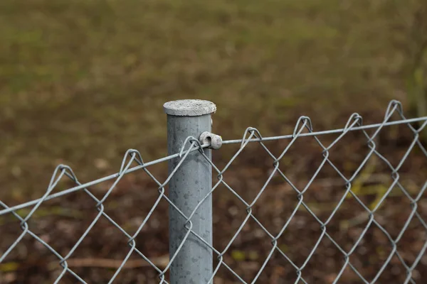 Fence made of metal posts and metal mesh — Stock Photo, Image