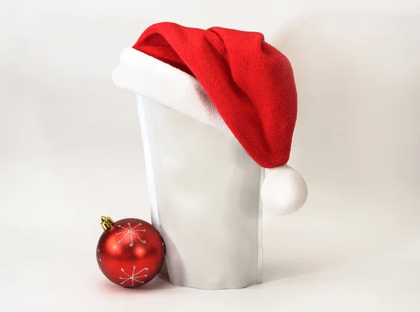 Template of paper ecological bag for storing coffee, tea on an isolated white background in a red hat and a round toy. Vacuum packaging for christmas and new year present