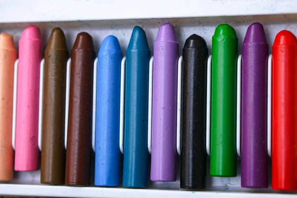 Multi-colored crayons in a white box for creativity