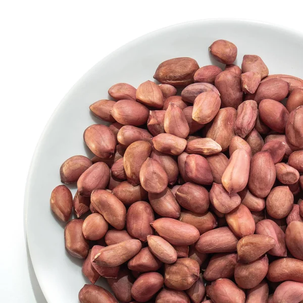 Peeled peanuts on a white isolated background. Food nuts delicious for your design for the site. kitchen theme — 스톡 사진