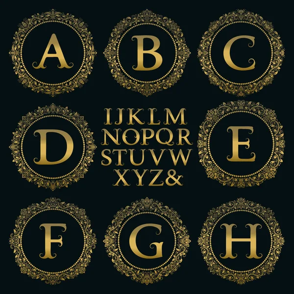 Vintage monogram kit. Golden letters and floral round frames for creating initial logo in victorian style. — Stock Vector