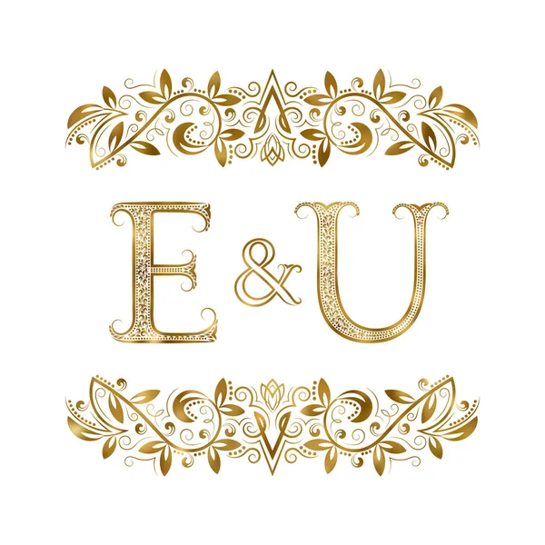 E und u Vintage Initialen Logo-Symbol. die Buchstaben sind von ornamentalen Elementen umgeben. — Stockvektor