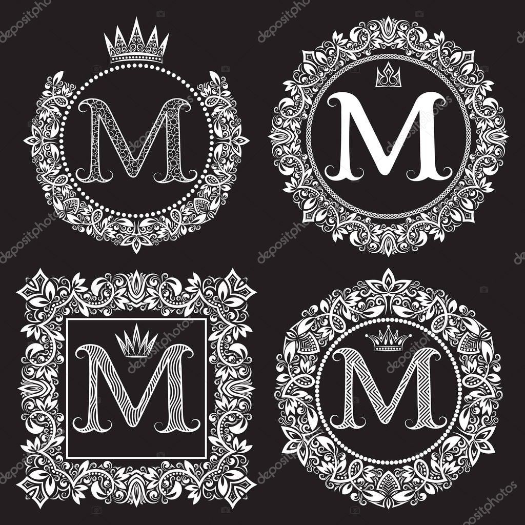 Vintage monograms set of M letter. Heraldic coats of arms in wreaths, round and square frames. White symbols on black.
