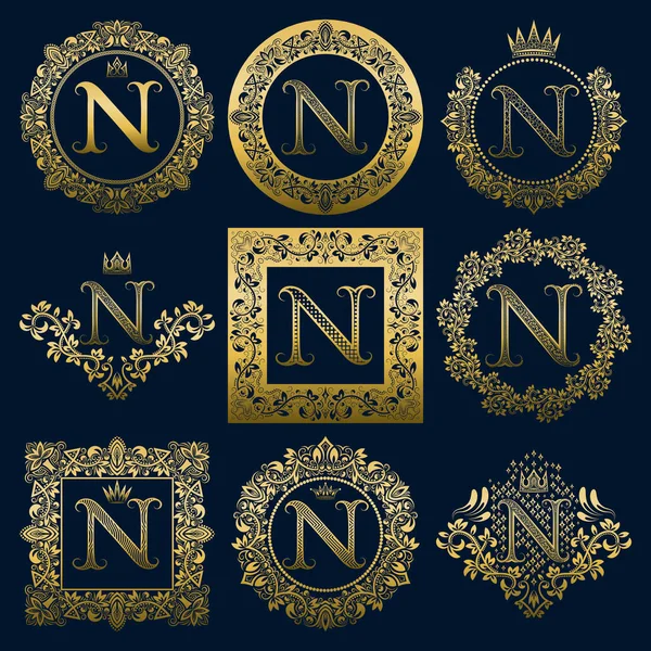 Vintage monograms set of N letter. Golden heraldic logos in wreaths, round and square frames. — Stock Vector