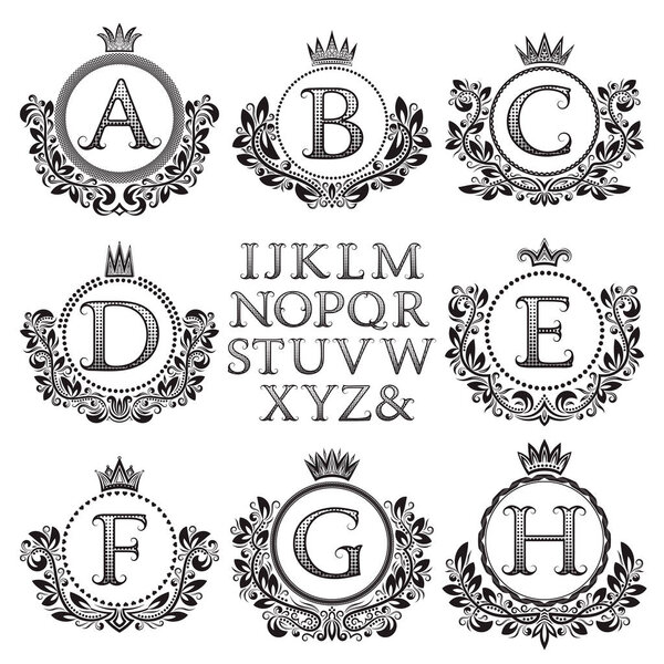 Vintage monogram kit. Black patterned letters and floral coat of arms frames for creating initial logo in antique style.