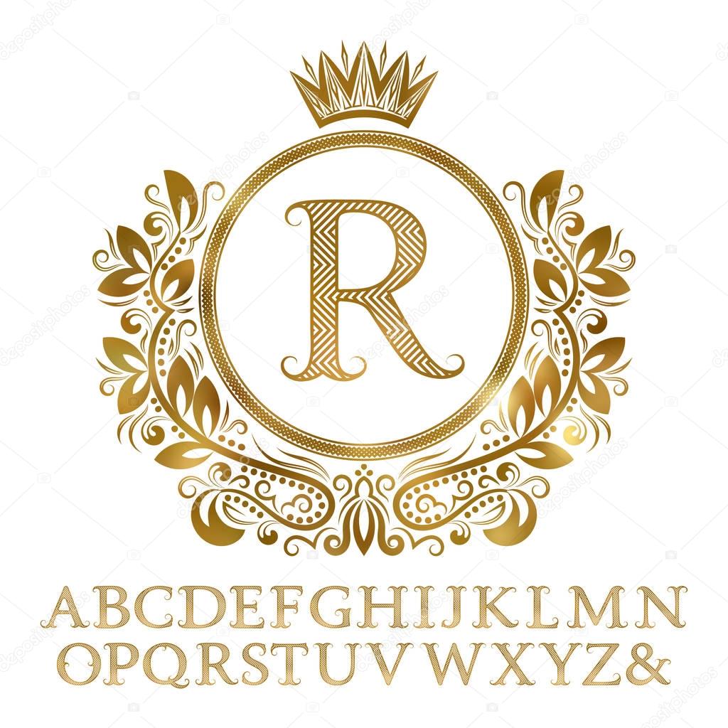 Golden patterned letters with initial monogram in coat of arms form. Shining font and elements kit for logo design.