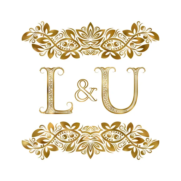 L en U vintage initialen logo symbool. De letters zijn omringd door decoratieve elementen. Bruiloft of zakelijke partners monogram in Koninklijke stijl. — Stockvector