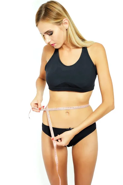 Young attractive woman measuring her hips — Stock Photo, Image