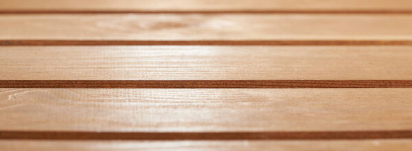 Horizontal shot of freshly painted glossy wooden floor board background.