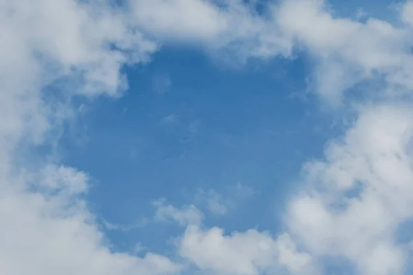 Horizontal shot of background blue sky and white clouds around.