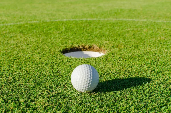 Golf into the hole — Stock Photo, Image