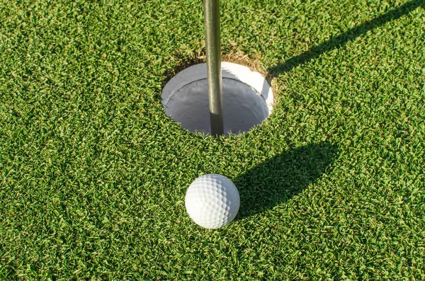 Golf into the hole — Stock Photo, Image