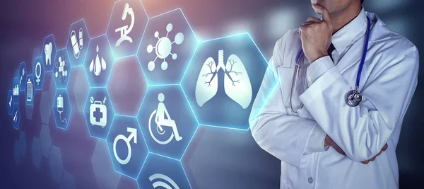 Doctor with stethoscope touching the digital icons — Stock Photo, Image