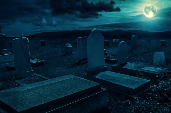 Creepy atmosphere in the cemetery with tombstone